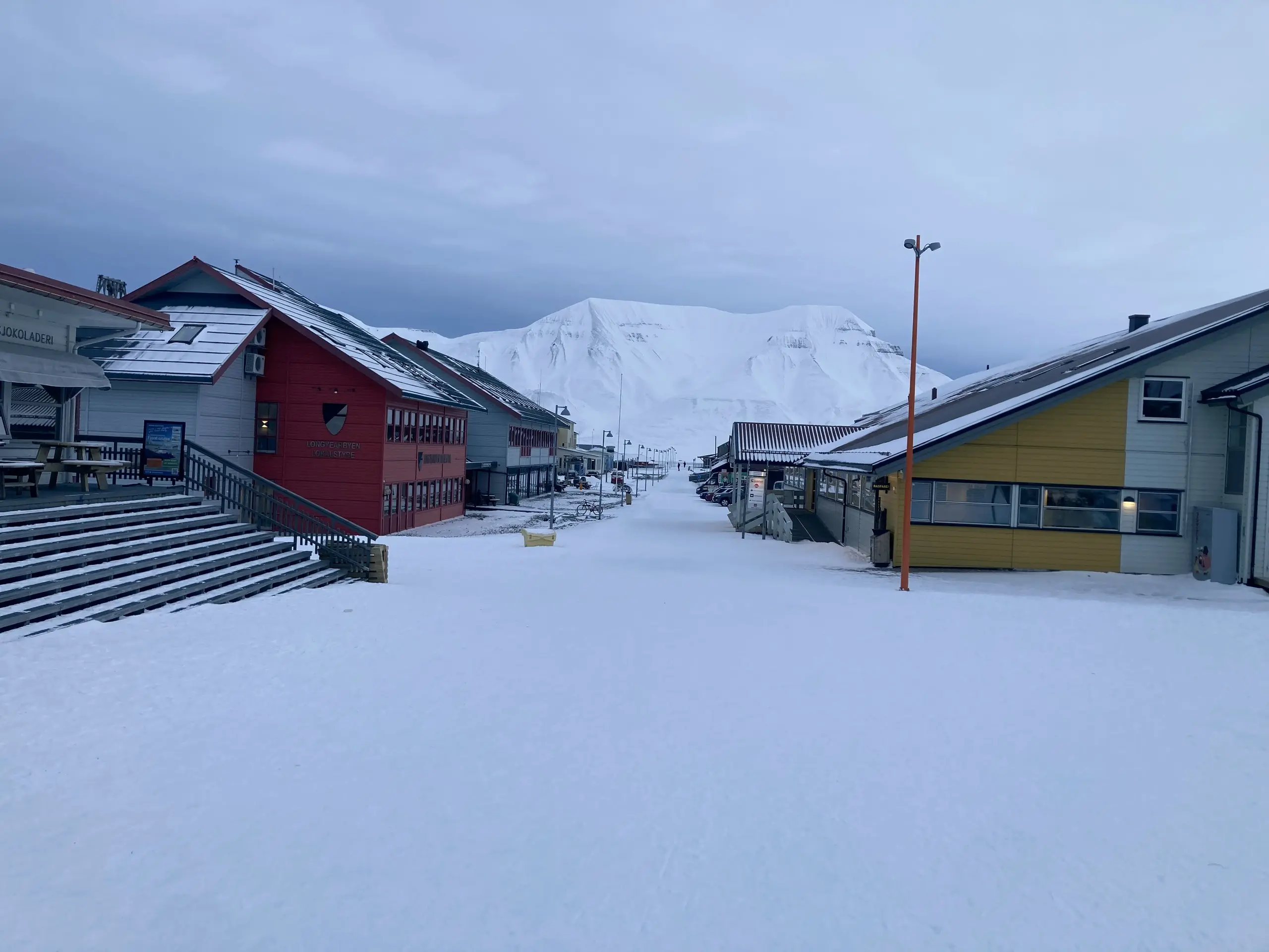 Empty snowy pedestrian street with colorful houses