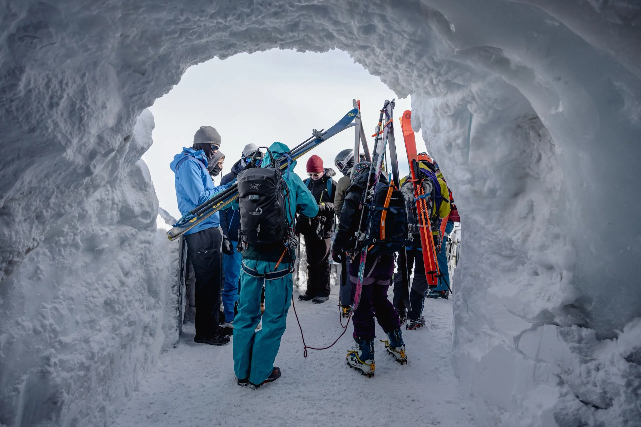 A tour group inside a blue glacier ice cave