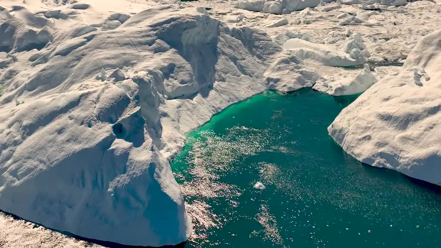 Aerial view of glacial ice and turquoise Arctic meltwater